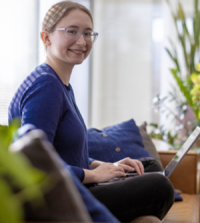 Woman sitting on couch with laptop
