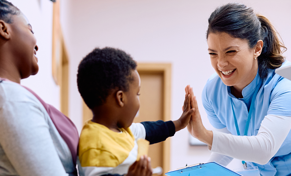 Doctor high-fiving young patient