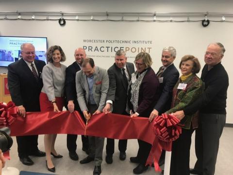 Group of people cutting a ribbon